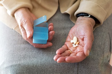 elderly man taking medications